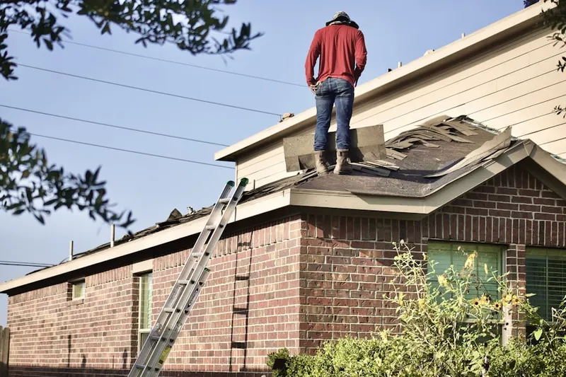 Professional roofer working on a residential roof in Madrona